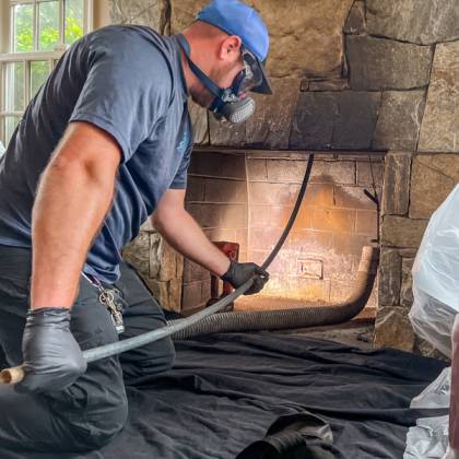 certified chimney sweep Woonsocket technician cleaning chimney