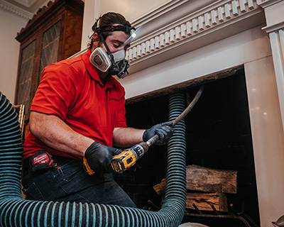 chimney inspection in Woonsocket technician inspecting chimney