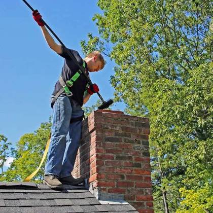 affordable chimney sweep Woonsocket technician cleaning chimney