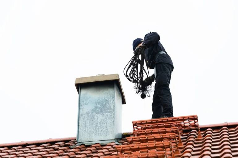 technician performing chimney cleaning services Woonsocket