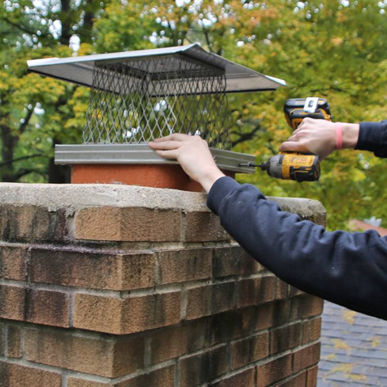 professional chimney cap installation in Worcester MA protecting chimney flues from water animals and debris
