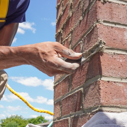 professional masonry chimney repair in Andover Massachusetts restoring damaged brickwork mortar joints and chimney structure