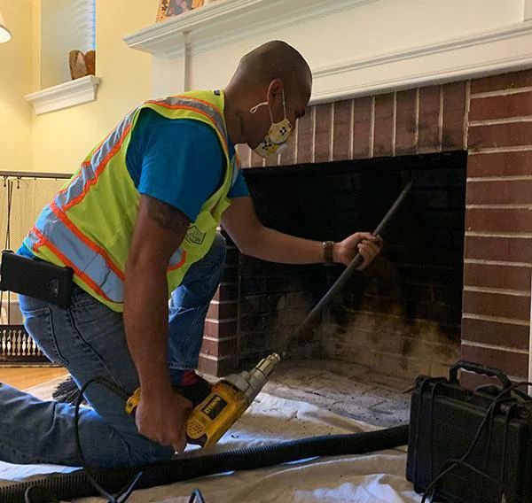 professional fireplace cleaning service in Worcester Massachusetts removing soot ash and fireplace buildup for safer operation